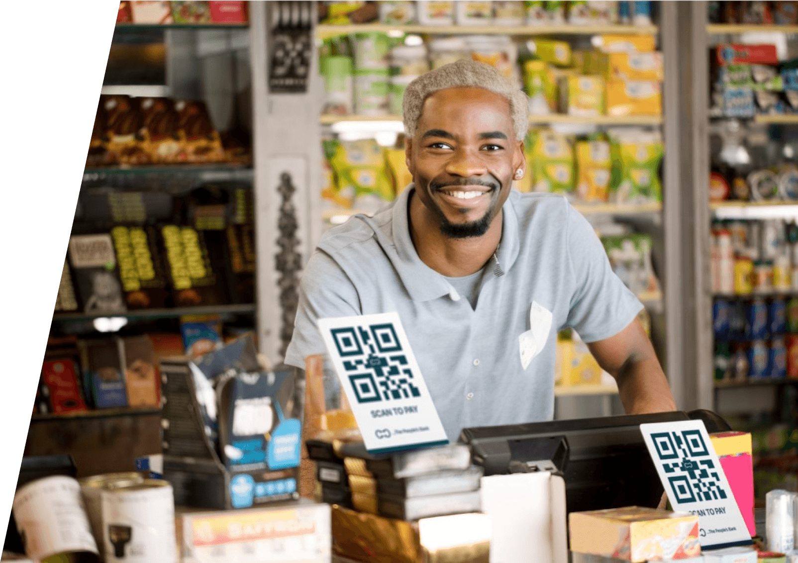 a store keeper smiling behind business counter