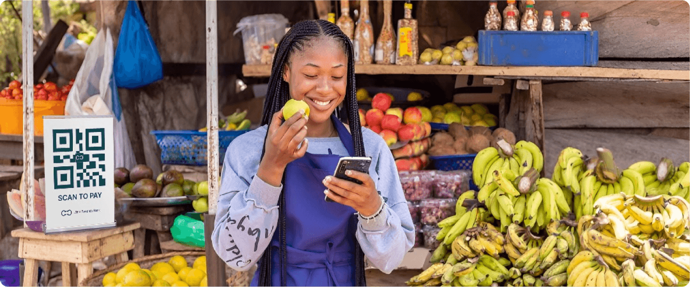 a woman smiling at her phone and eating apples